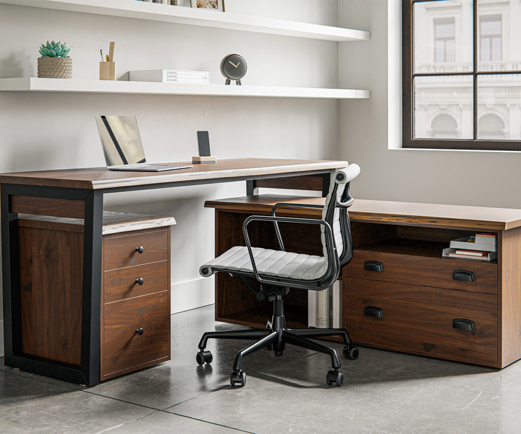 An L shaped desk against a white wall with two white shelves above and a office chair in front